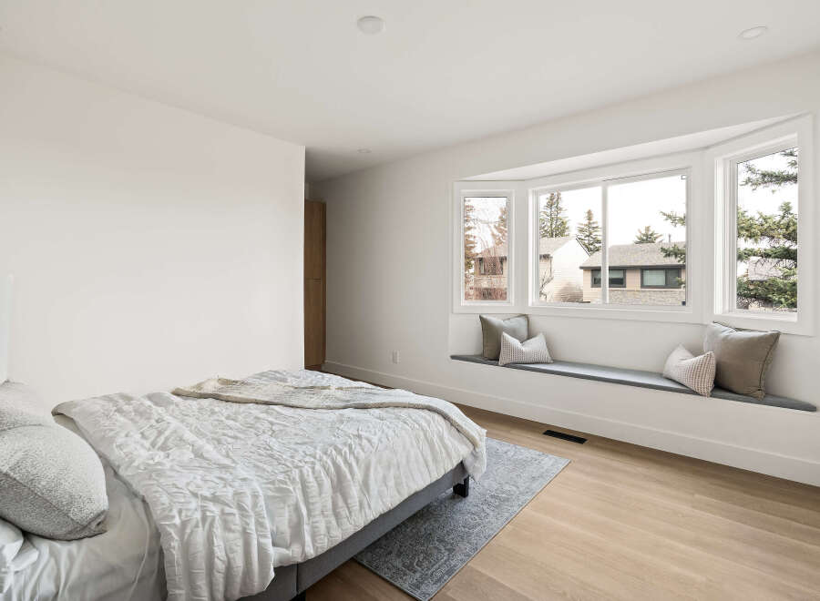 This stunning bedroom boasts a bright and airy atmosphere, perfect for relaxation.
