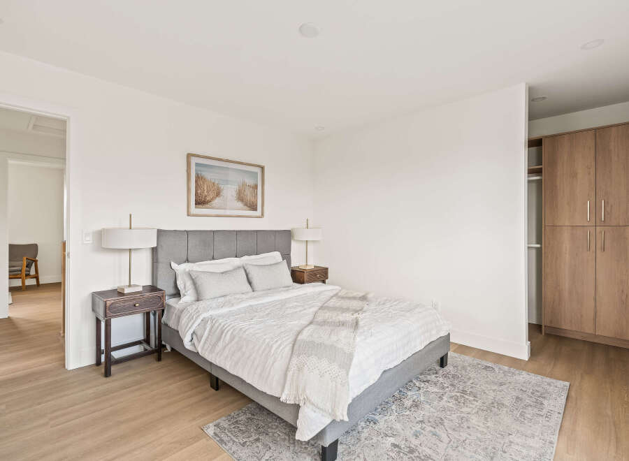 This inviting bedroom features a comfortable bed with a stylish headboard, creating a relaxing retreat.