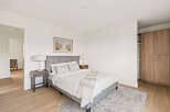 This inviting bedroom features a comfortable bed with a stylish headboard, creating a relaxing retreat.