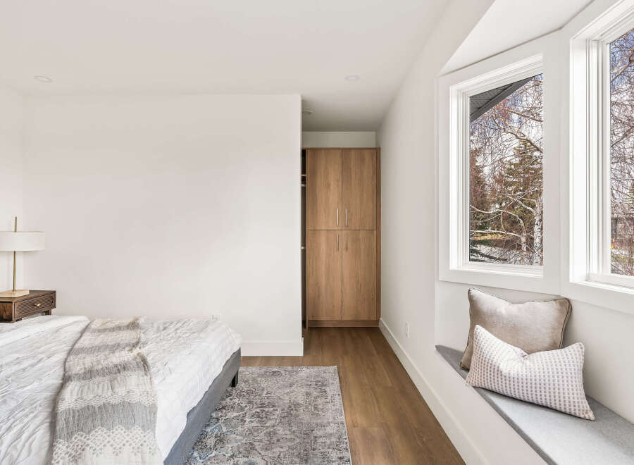This stunning bedroom boasts a modern design with clean lines and a neutral color palette, creating a serene and inviting atmosphere.