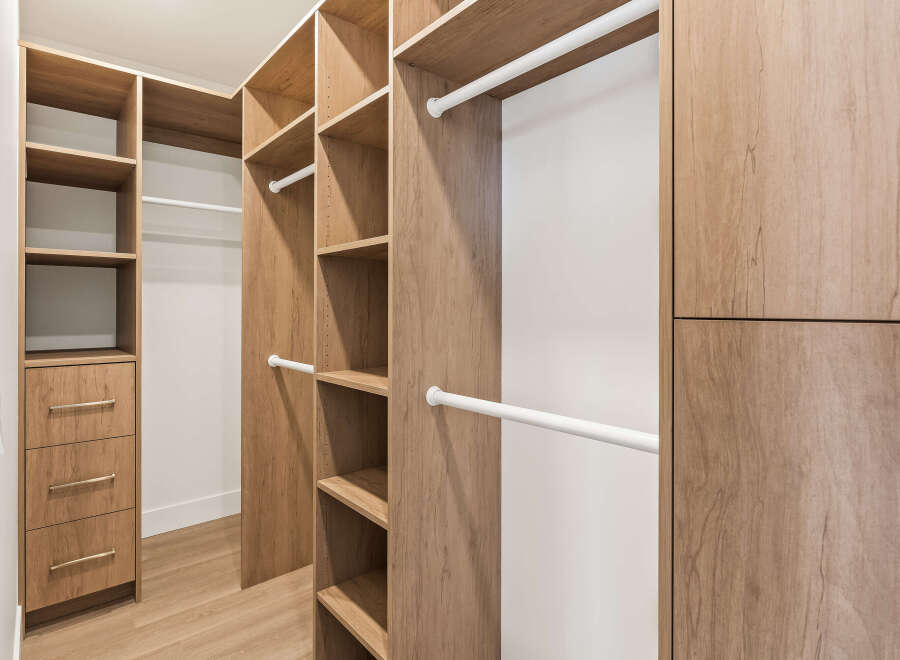 Step into luxury with this custom-designed walk-in closet, offering ample storage and organization.