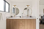 This stunning bathroom features a modern design with a double vanity.