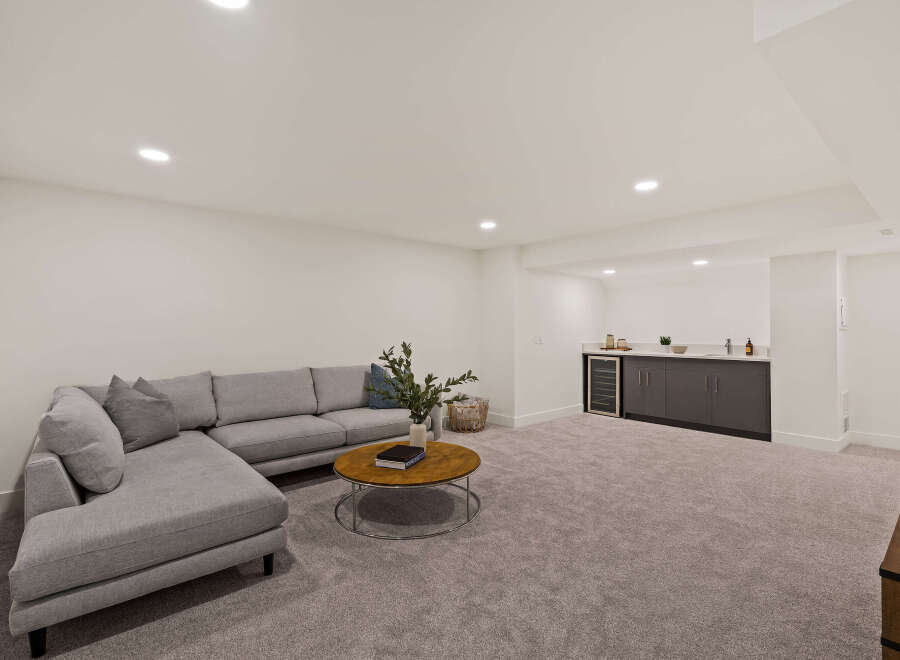 This stunning living space boasts a modern design with a comfortable sectional sofa, perfect for relaxing and entertaining.