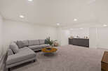 This stunning living space boasts a modern design with a comfortable sectional sofa, perfect for relaxing and entertaining.