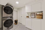 This modern laundry room features a sleek, stacked Samsung washer and dryer, maximizing space and efficiency.