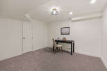 This inviting room features a sleek black desk and a comfortable chair, perfect for a home office or study space.