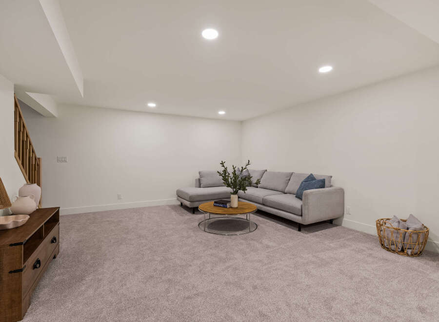 This inviting living space features a modern gray sectional sofa, perfect for relaxing and entertaining.