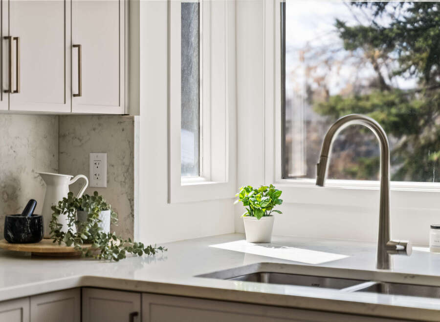This stunning kitchen boasts a modern design with sleek cabinetry and a beautiful marble countertop.