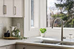 This stunning kitchen boasts a modern design with sleek cabinetry and a beautiful marble countertop.