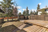 Enjoy outdoor living in this beautiful backyard! This property features a spacious wooden deck, perfect for entertaining or relaxing.