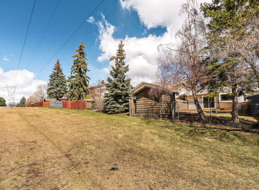 This property offers a serene outdoor space with a lush green lawn, perfect for relaxation and recreation.