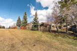 This property offers a serene outdoor space with a lush green lawn, perfect for relaxation and recreation.