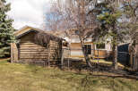 Discover the charm of this property, featuring a well-maintained wooden shed and a secure chain-link fence.