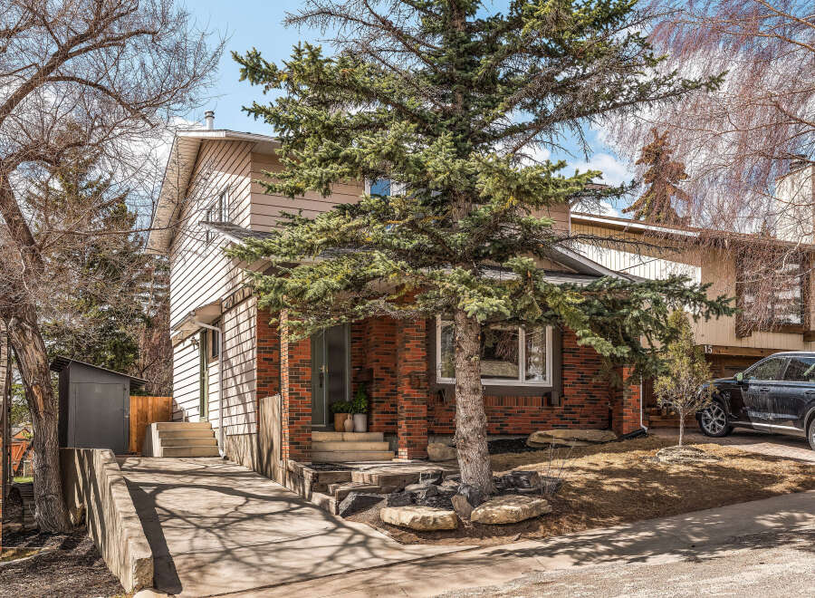 This charming two-story home boasts a classic brick facade and a welcoming entrance.