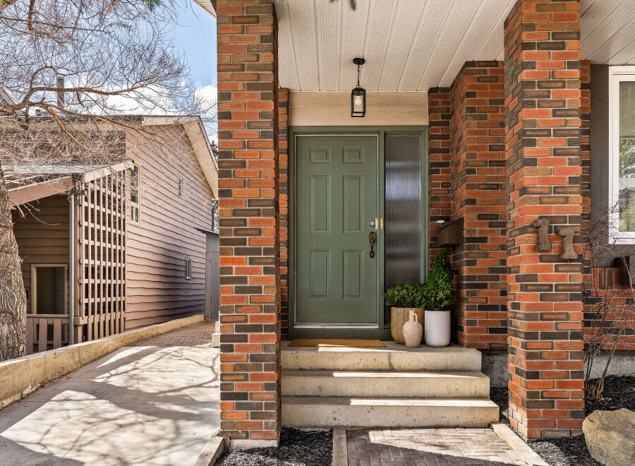 This stunning property boasts a beautiful brick facade and a welcoming front entrance.