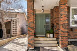 This stunning property boasts a beautiful brick facade and a welcoming front entrance.