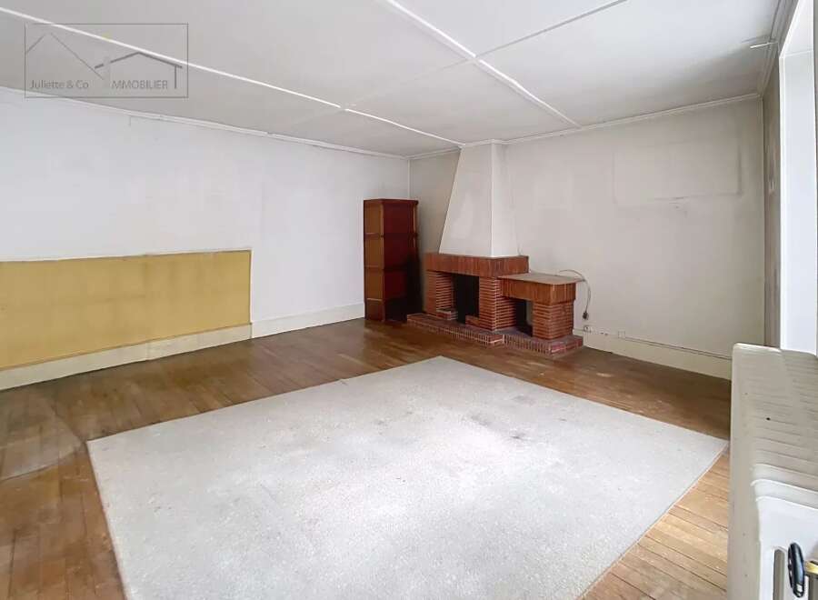Discover the charm of this inviting living space, featuring a cozy fireplace and warm wooden floors.