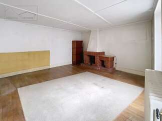 Discover the charm of this inviting living space, featuring a cozy fireplace and warm wooden floors.