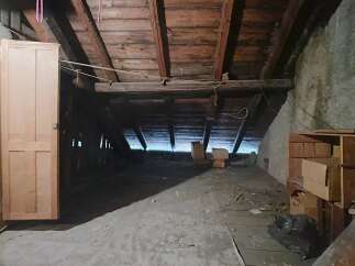 Explore the potential of this unfinished attic space, perfect for renovation or additional storage.