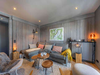 This cozy living space features a modern gray sectional sofa, perfect for relaxing.