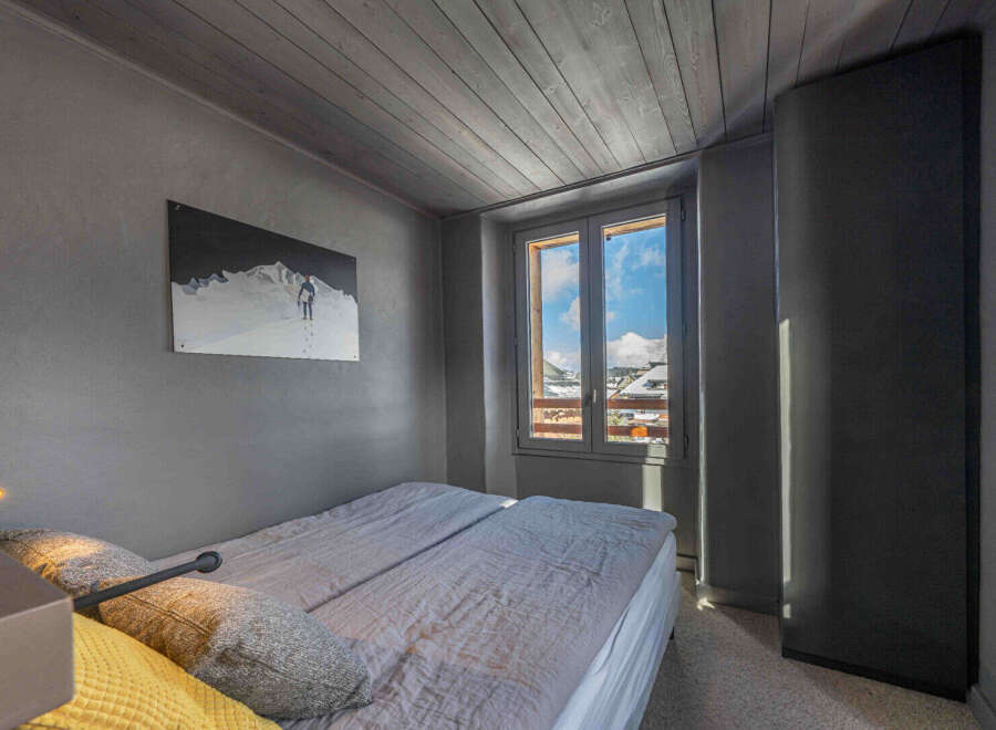 This cozy bedroom features a comfortable bed and a stunning view through the window.