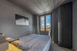 This cozy bedroom features a comfortable bed and a stunning view through the window.