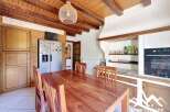 Discover the charm of this inviting kitchen, featuring a warm wooden dining table and chairs, perfect for family gatherings.