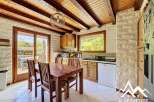 This charming kitchen features a warm, inviting atmosphere with its wooden ceiling beams and cabinetry.