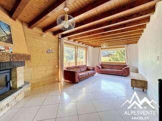 Discover the charm of this stunning property, featuring a cozy living room with a fireplace and exposed wooden beams.