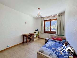Discover this charming property featuring a cozy bedroom with a comfortable bed and a study area.