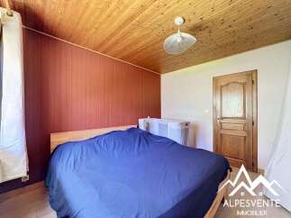 Discover this charming bedroom featuring a cozy ambiance and rustic wooden accents.