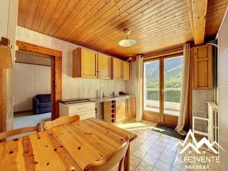 Discover this charming property featuring a cozy kitchen with wooden cabinets and a dining area.