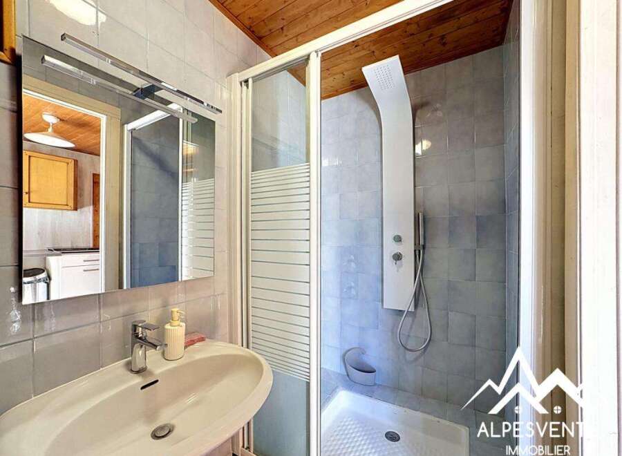 This bathroom features a modern design with a sleek shower and a stylish sink.