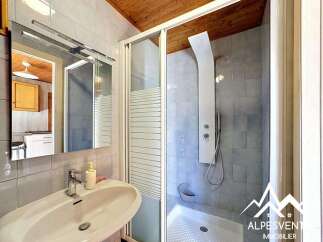 This bathroom features a modern design with a sleek shower and a stylish sink.