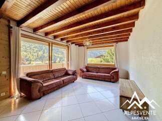 Discover the charm of this stunning property, featuring a spacious living area with a cozy sofa and large windows that offer breathtaking views.