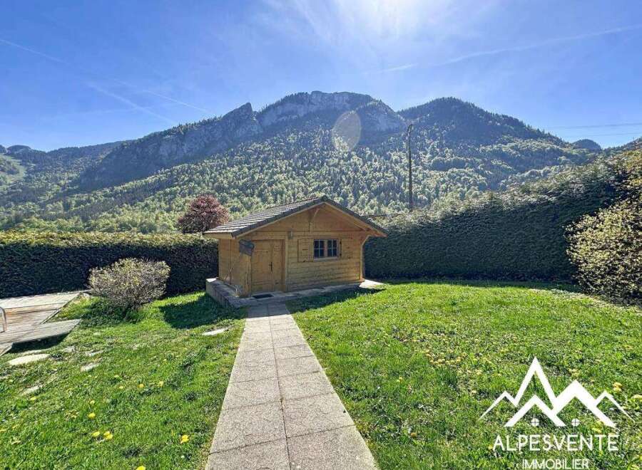 Discover a charming wooden cabin nestled amidst breathtaking mountain scenery.