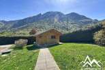 Discover a charming wooden cabin nestled amidst breathtaking mountain scenery.