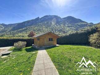 Discover a charming wooden cabin nestled amidst breathtaking mountain scenery.