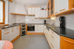 This charming kitchen boasts a classic design with a touch of warmth.