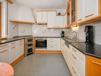 This charming kitchen boasts a classic design with a touch of warmth.