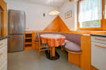 This charming kitchen features a cozy dining nook, perfect for enjoying meals.