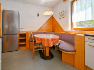 This charming kitchen features a cozy dining nook, perfect for enjoying meals.