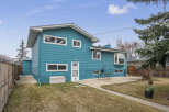 This stunning property boasts a vibrant teal exterior, offering a unique curb appeal.