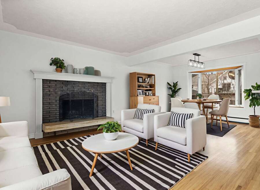 Step into this inviting living space, featuring a cozy fireplace and stylish seating.
