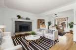 Step into this inviting living space, featuring a cozy fireplace and stylish seating.