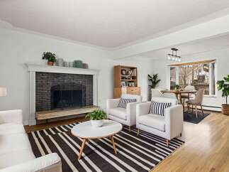 Step into this inviting living space, featuring a cozy fireplace and stylish seating.