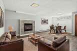 Step into luxury with this stunning living space, featuring a cozy fireplace and elegant leather seating.