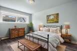 Step into this serene bedroom, featuring a charming wrought iron bed and a calming color palette.