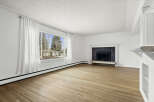 This spacious living room boasts beautiful hardwood floors and a cozy fireplace, perfect for relaxing evenings.