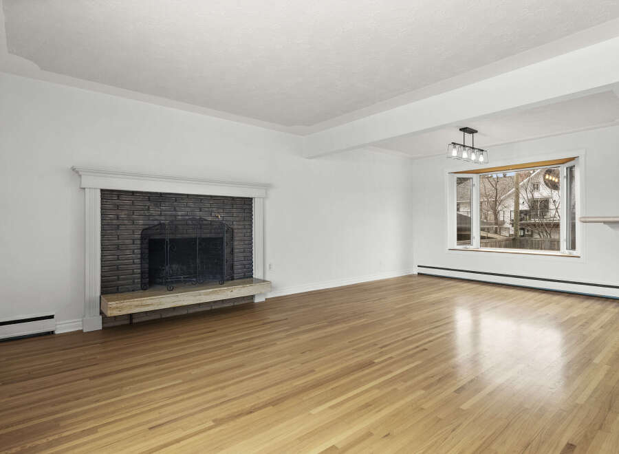 This stunning living room boasts a cozy fireplace, perfect for those chilly evenings.